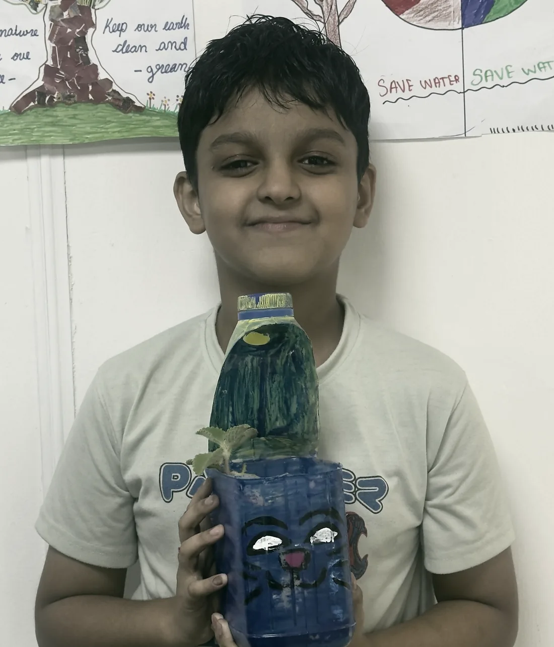 A student holding a model he built at PHLOEM Junior Creative Lab in Abu Dhabi