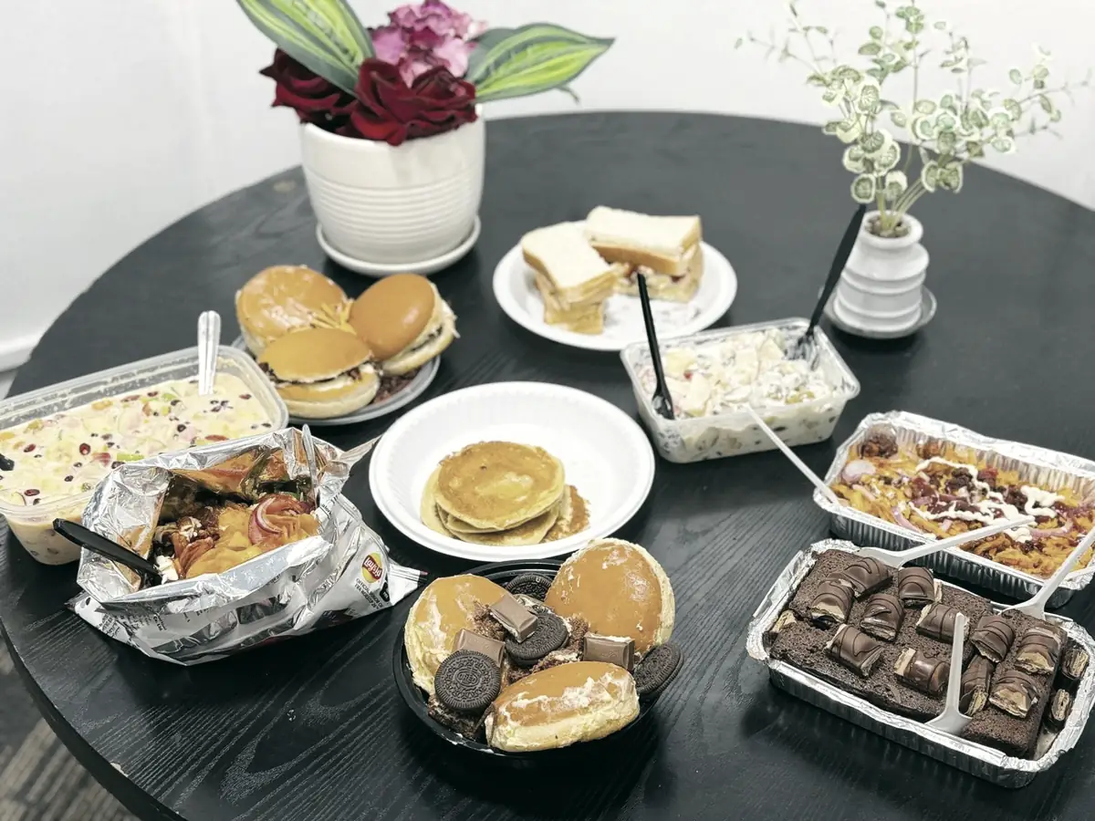 A table laid with food before a shared meal at PHLOEM Learning in Abu Dhabi