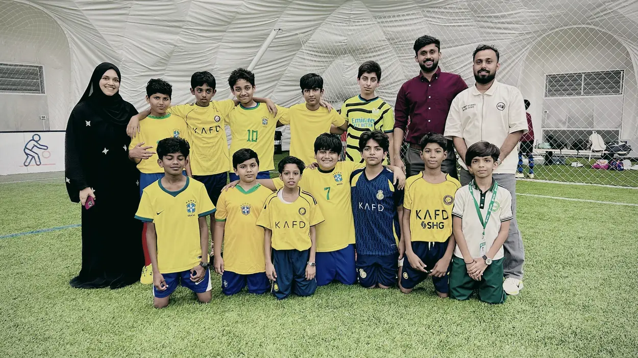 The PHLOEM Learning football team with their coaches before a match in Abu Dhabi
